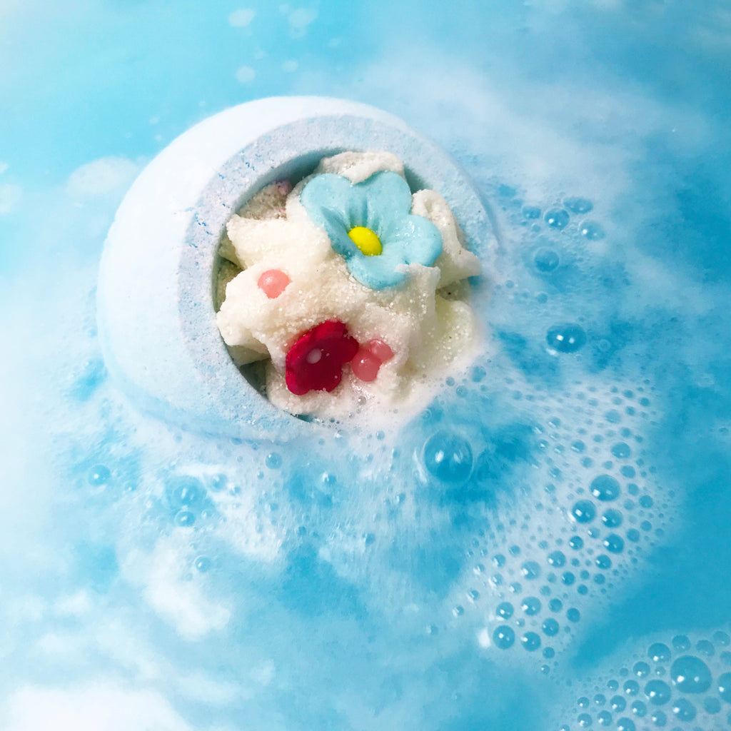 Cotton Flower Bath Blaster fizzing, releasing its blue hue into the water